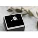 Sterling silver ring with oval faceted moonstone set in a bezel setting with simple silver ring band. 